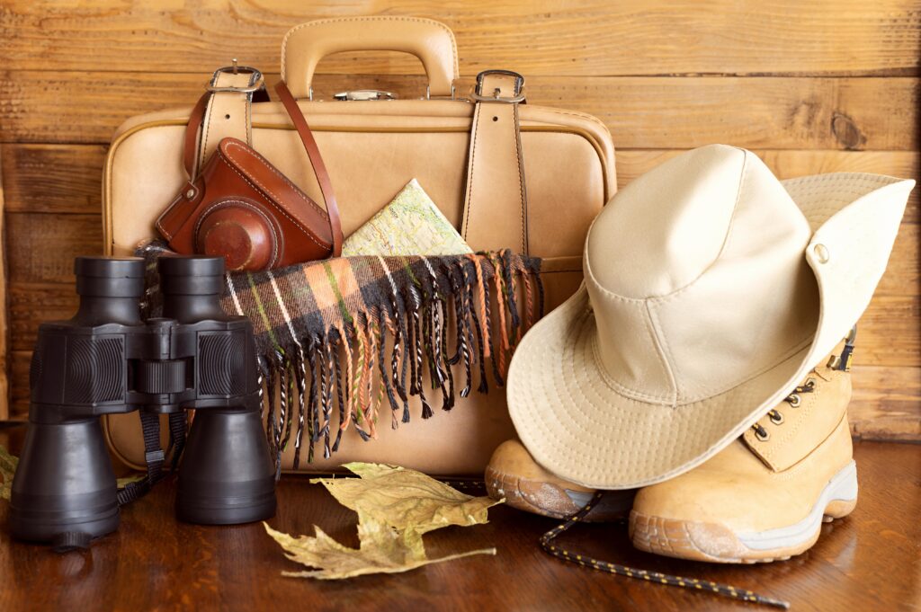 Travel Items, binoculars, hat, boots, camera